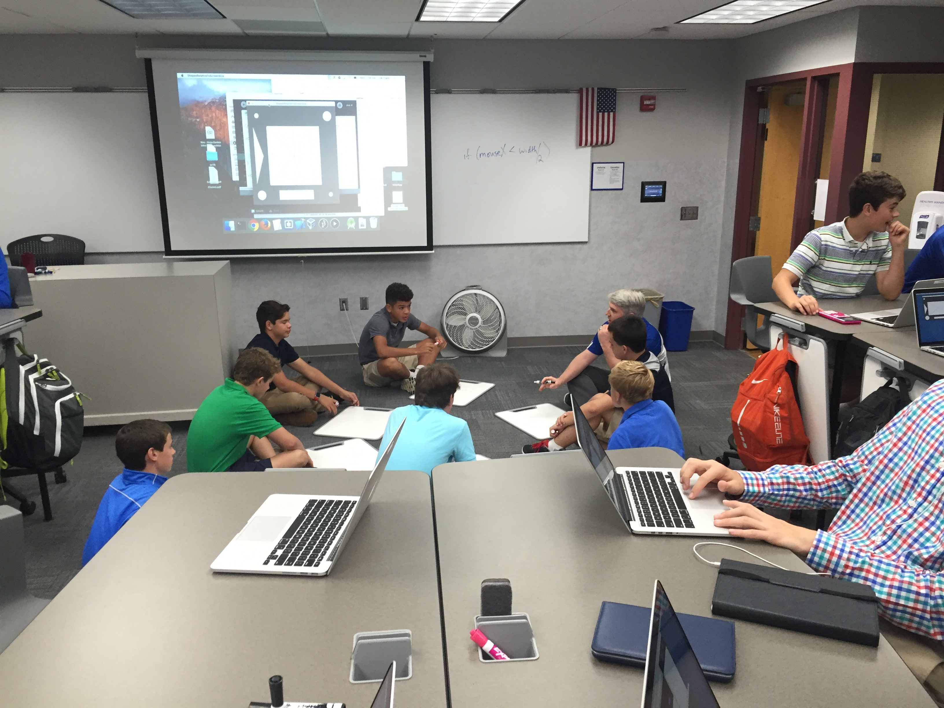 Students receiving extra attention from Mr. Clark in Introduction to Computer Science